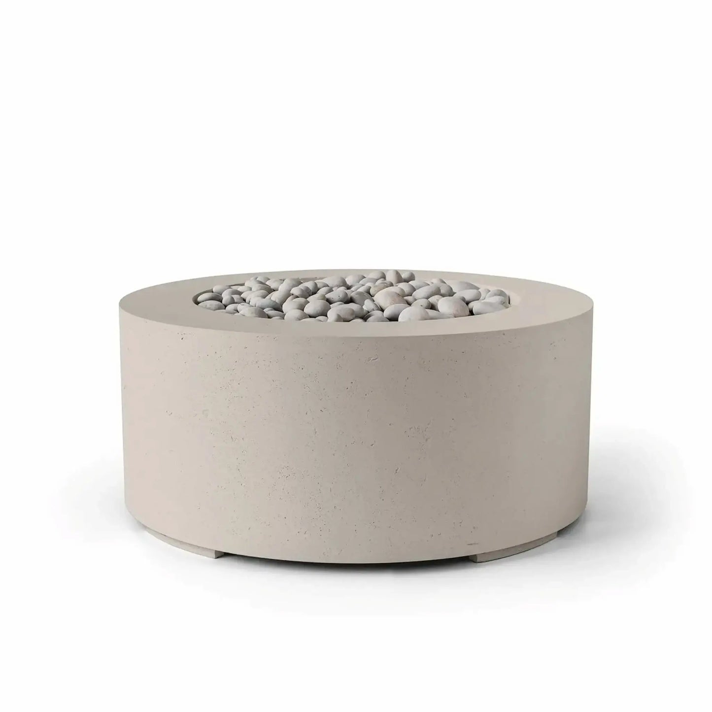 HPC Fire Hearth Products Controls Dekko GFRC Concrete Belmont Fire Pit in Clay finish with ivory stone media. This round 36-inch fire pit features a warm beige concrete tone, durable GFRC construction, and a recessed fire bowl filled with decorative smooth stones. The soft neutral color palette and contemporary cylindrical shape make it a stylish addition to patios, outdoor seating areas, courtyards, and landscape designs.