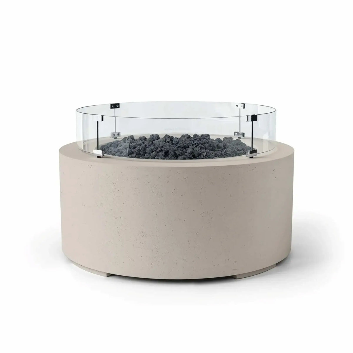 HPC Fire Hearth Products Controls Dekko GFRC Concrete Belmont Fire Pit in Clay finish featuring Lava Rock media and a Tempered Glass Wind Guard. The round fire pit showcases a textured beige GFRC concrete body, dark volcanic lava rock fire media, and a clear circular windscreen designed to help maintain flame stability. This Belmont Fire Pit creates a striking focal point for patios, decks, and outdoor gathering spaces.