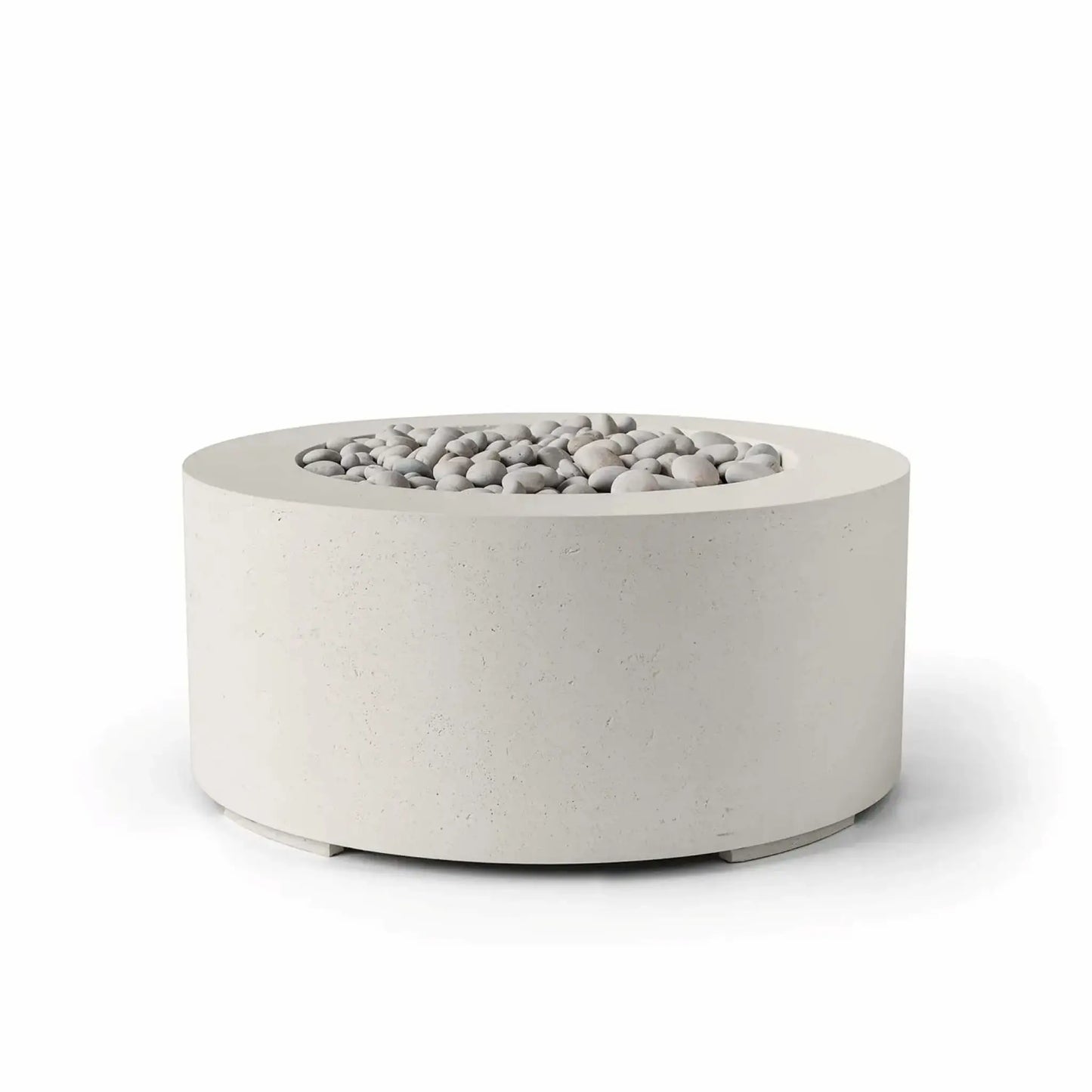 HPC Fire Hearth Products Controls Dekko GFRC Concrete Belmont Fire Pit in Limestone finish featuring ivory stone fire media. This modern round fire pit showcases a soft limestone-colored GFRC concrete exterior, wide top rim, and recessed burner area filled with smooth decorative stones. Displayed on a clean white background, the Belmont Fire Pit offers a refined contemporary design for luxury patios and outdoor living spaces.