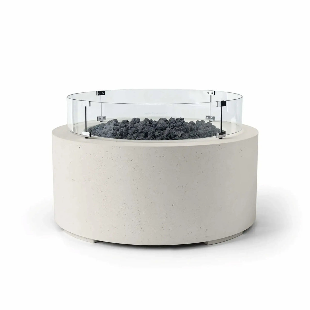 HPC Fire Hearth Products Controls Dekko GFRC Concrete Belmont Fire Pit in Limestone finish with Lava Rock fire media and a Tempered Glass Wind Guard. The round outdoor fire pit features an off-white GFRC concrete base, dark volcanic lava rock surrounding the burner area, and a circular clear glass windscreen secured with stainless steel brackets. Displayed on a clean white background, this Belmont Fire Pit offers a modern, durable centerpiece for upscale patios and outdoor living spaces.