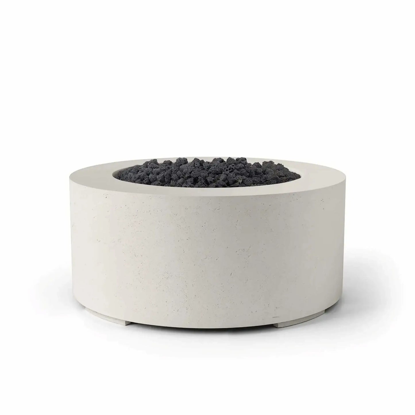 HPC Fire Hearth Products Controls Dekko GFRC Concrete Belmont Fire Pit in Limestone finish with black lava rock media. The round GFRC concrete fire pit combines a light limestone-toned exterior with rugged dark volcanic rock for striking visual contrast. Its low-profile cylindrical design, durable construction, and modern styling make the Belmont Fire Pit ideal for residential patios, rooftop decks, and commercial outdoor environments.