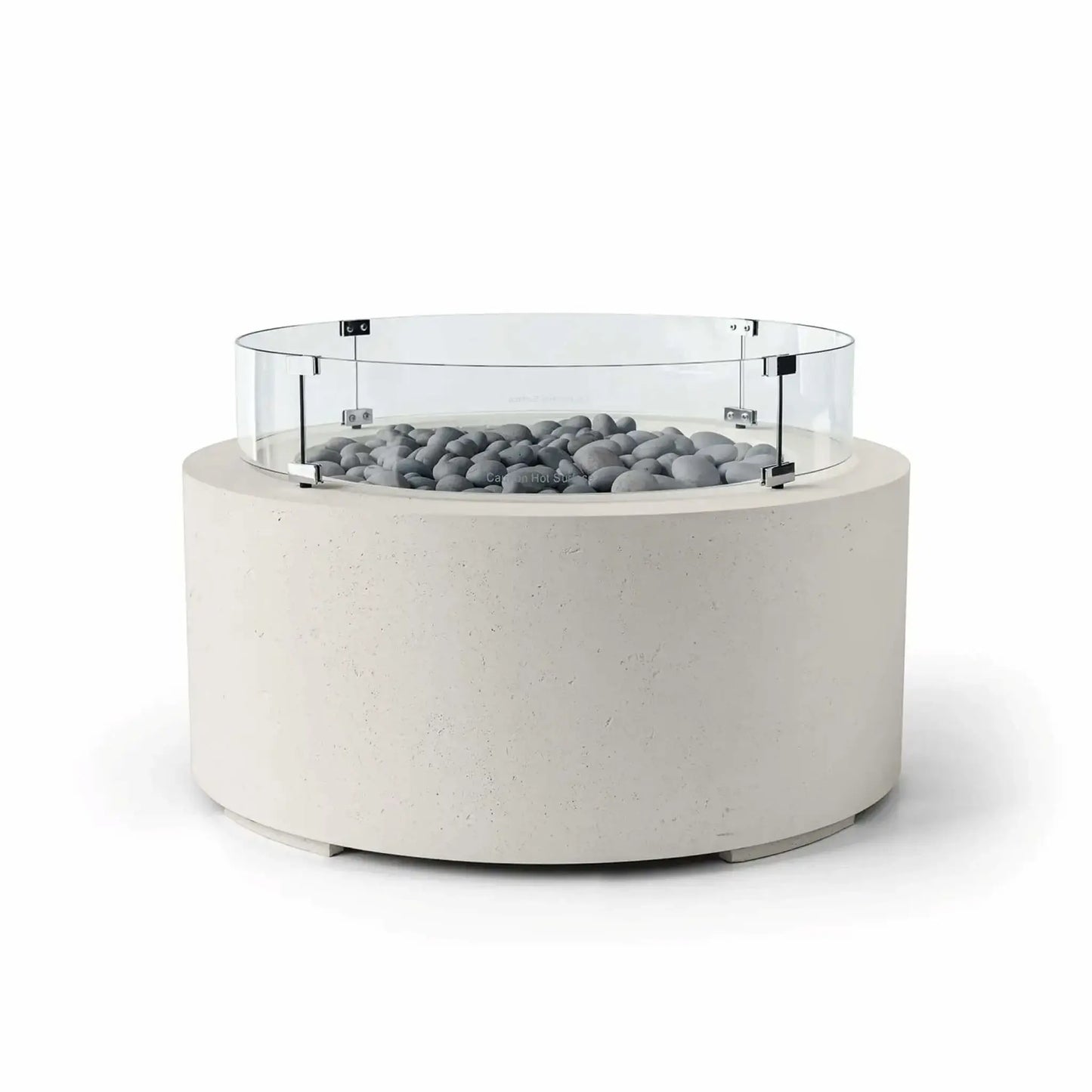 HPC Fire Hearth Products Controls Dekko GFRC Concrete Belmont Fire Pit in Limestone finish featuring Slate Stone fire media and a Tempered Glass Wind Guard. This contemporary round fire pit showcases a light limestone-colored concrete body, smooth gray slate stones around the burner area, and a transparent circular glass windscreen supported by metal hardware. The minimalist design makes the Belmont Fire Pit an elegant addition to modern outdoor entertaining areas.