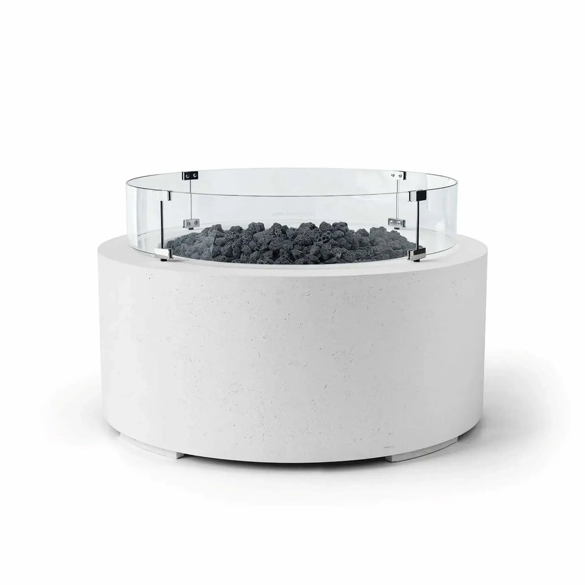 HPC Fire Hearth Products Controls Dekko GFRC Concrete Belmont Fire Pit in Natural finish featuring Lava Rock media and a Tempered Glass Wind Guard. This round outdoor fire pit combines a crisp white GFRC concrete body with rugged black lava rock and a transparent circular glass windscreen for added flame protection. The Belmont Fire Pit’s modern silhouette and contrasting materials create a striking focal point for patios and outdoor gathering areas.