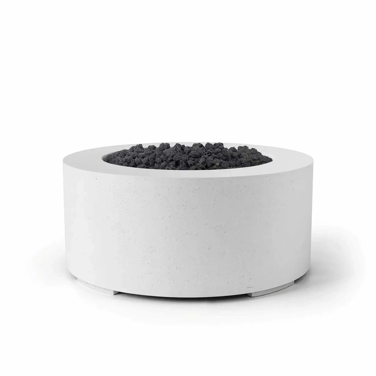 HPC Fire Hearth Products Controls Dekko GFRC Concrete Belmont Fire Pit in Natural finish with black lava rock media. The round outdoor fire pit features durable GFRC concrete construction, a recessed burner compartment, and a smooth cylindrical profile. The contrast between the light natural concrete finish and rugged dark lava rock highlights the Belmont Fire Pit’s contemporary design, making it a striking centerpiece for residential patios, rooftop decks, and outdoor gathering spaces.