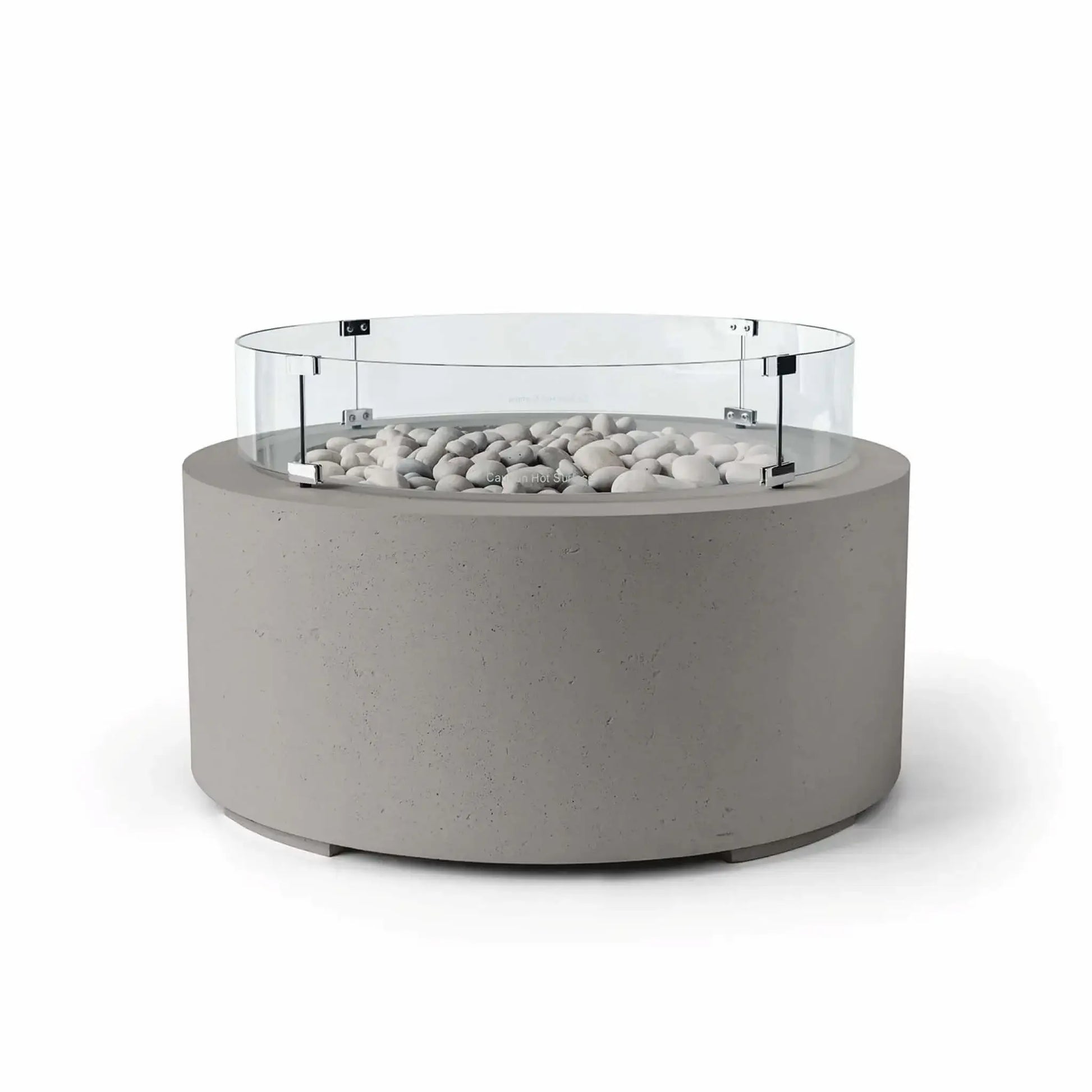 HPC Fire Hearth Products Controls Dekko GFRC Concrete Belmont Fire Pit in Sandstone finish with Ivory Stone fire media and a Tempered Glass Wind Guard. The warm beige sandstone-colored concrete base is paired with smooth ivory stones and surrounded by a circular clear glass windscreen that helps shield flames from wind. Displayed on a white background, this Belmont Fire Pit brings natural warmth and modern design to outdoor living environments.