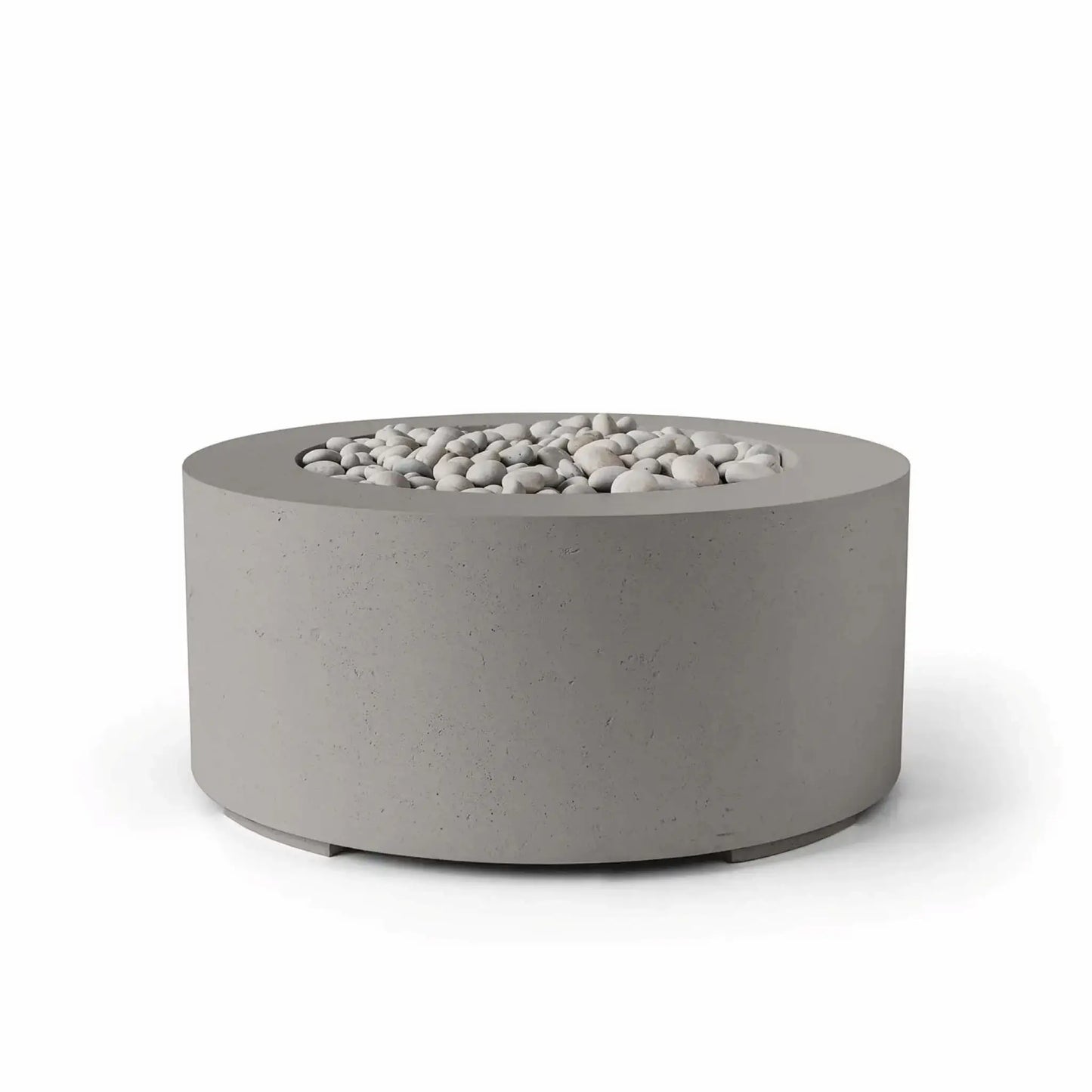HPC Fire Hearth Products Controls Dekko GFRC Concrete Belmont Fire Pit in Sandstone finish with ivory stone fire media. This contemporary round fire pit features a warm sandstone-gray concrete exterior, durable GFRC construction, and a recessed burner opening filled with smooth decorative ivory stones. Displayed on a white background, the Belmont Fire Pit offers a sophisticated blend of modern design and outdoor functionality for luxury patios and landscape projects.