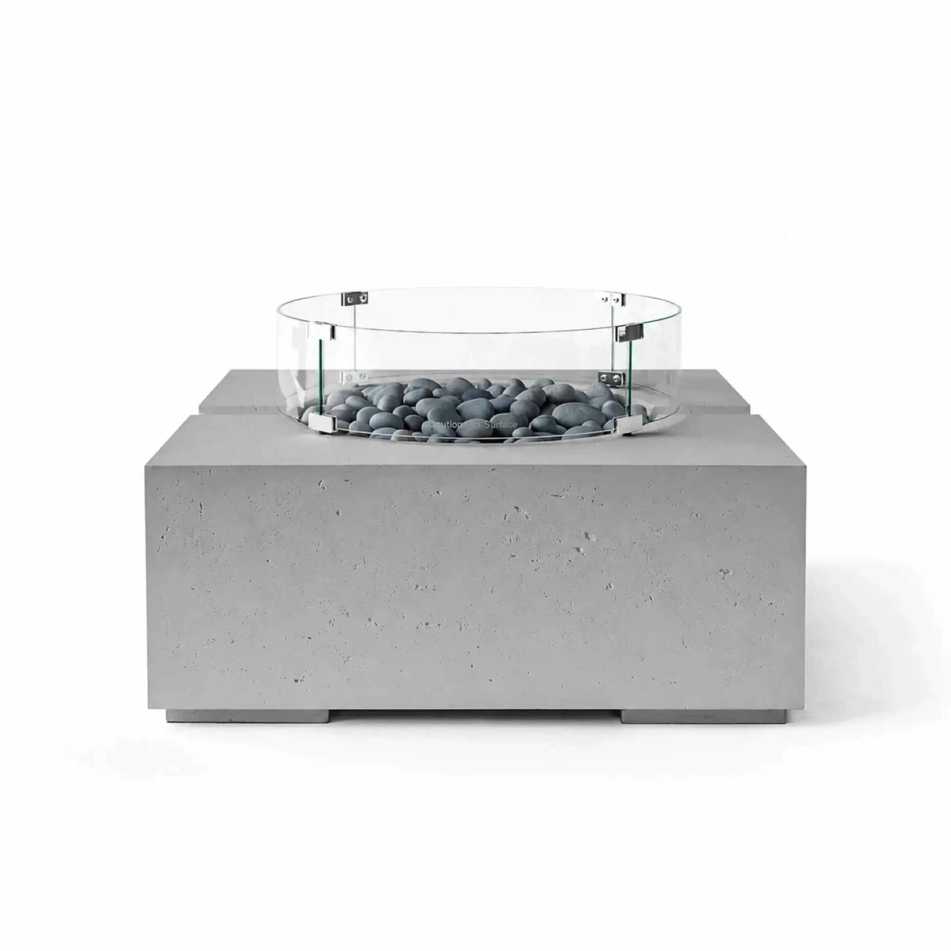 HPC Fire Hearth Products Controls Dekko GFRC Concrete Bravo 32 x 32 Fire Pit in Charcoal finish with Slate Stone fire media and a tempered glass wind guard. The dark concrete base and smooth gray stones create a sleek contemporary look, while the circular glass guard surrounds the burner area, emphasizing safety and modern outdoor design.