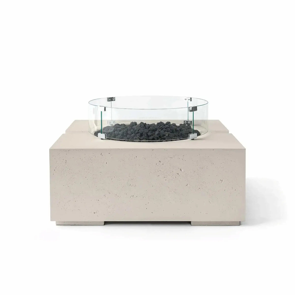 HPC Fire Hearth Products Controls Dekko GFRC Concrete Bravo 32 x 32 Fire Pit in Clay finish with black lava rock fire media and a clear tempered glass wind guard. The warm neutral concrete body contrasts with the dark volcanic rock, highlighting the fire pit’s contemporary outdoor design, textured GFRC construction, and elevated burner platform.