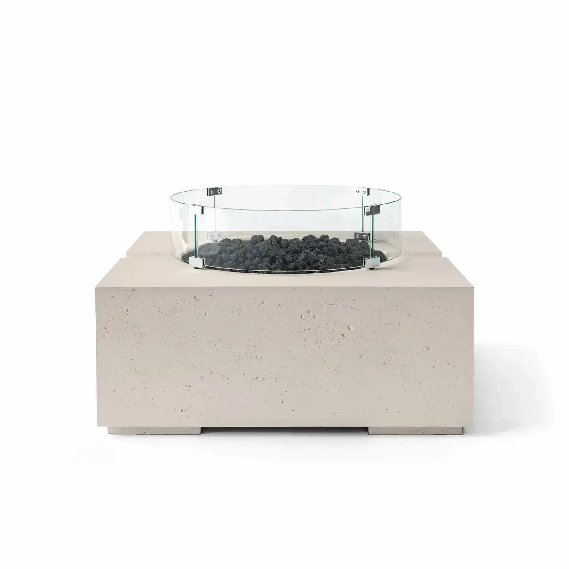 HPC Fire Hearth Products Controls Dekko GFRC Concrete Bravo 32 x 32 Fire Pit in Clay finish with black lava rock fire media and a clear tempered glass wind guard. The warm neutral concrete body contrasts with the dark volcanic rock, highlighting the fire pit’s contemporary outdoor design, textured GFRC construction, and elevated burner platform.