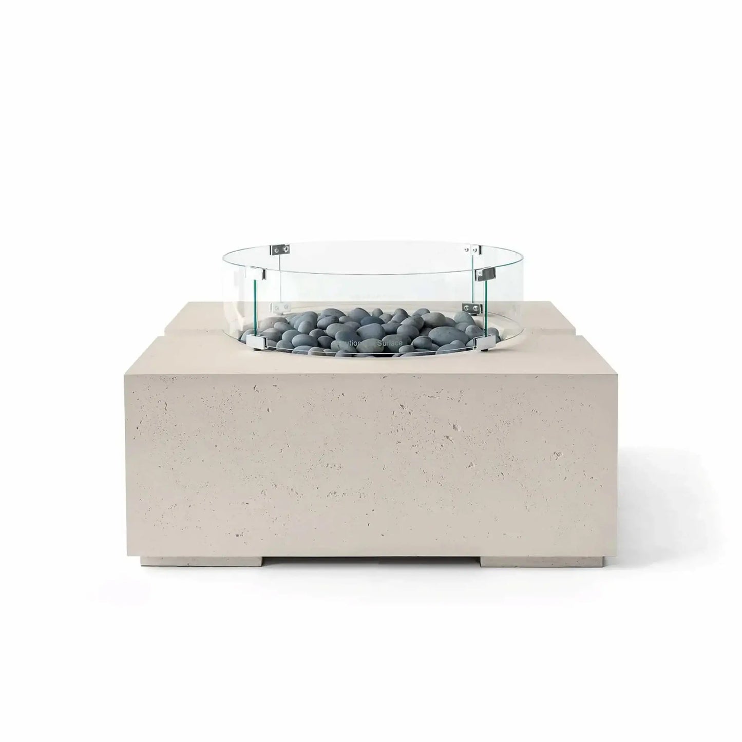 HPC Fire Hearth Products Controls Dekko GFRC Concrete Bravo 32 x 32 Fire Pit in Clay finish featuring Slate Stone fire media and a tempered glass wind guard. This modern square fire pit combines a warm beige textured concrete base with smooth gray decorative stones, offering a refined outdoor gathering centerpiece in a clean studio product image.