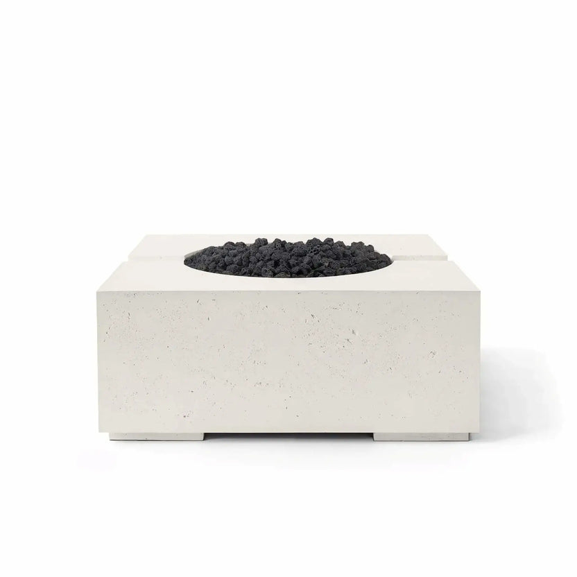 HPC Fire Hearth Products Controls Dekko GFRC Concrete Bravo 32 x 32 Fire Pit shown in Limestone finish with black Lava Rock media. The image highlights the fire pit’s modern square silhouette, textured GFRC concrete construction, elevated base supports, and contrasting dark volcanic rock fire media designed for stylish outdoor living environments.
