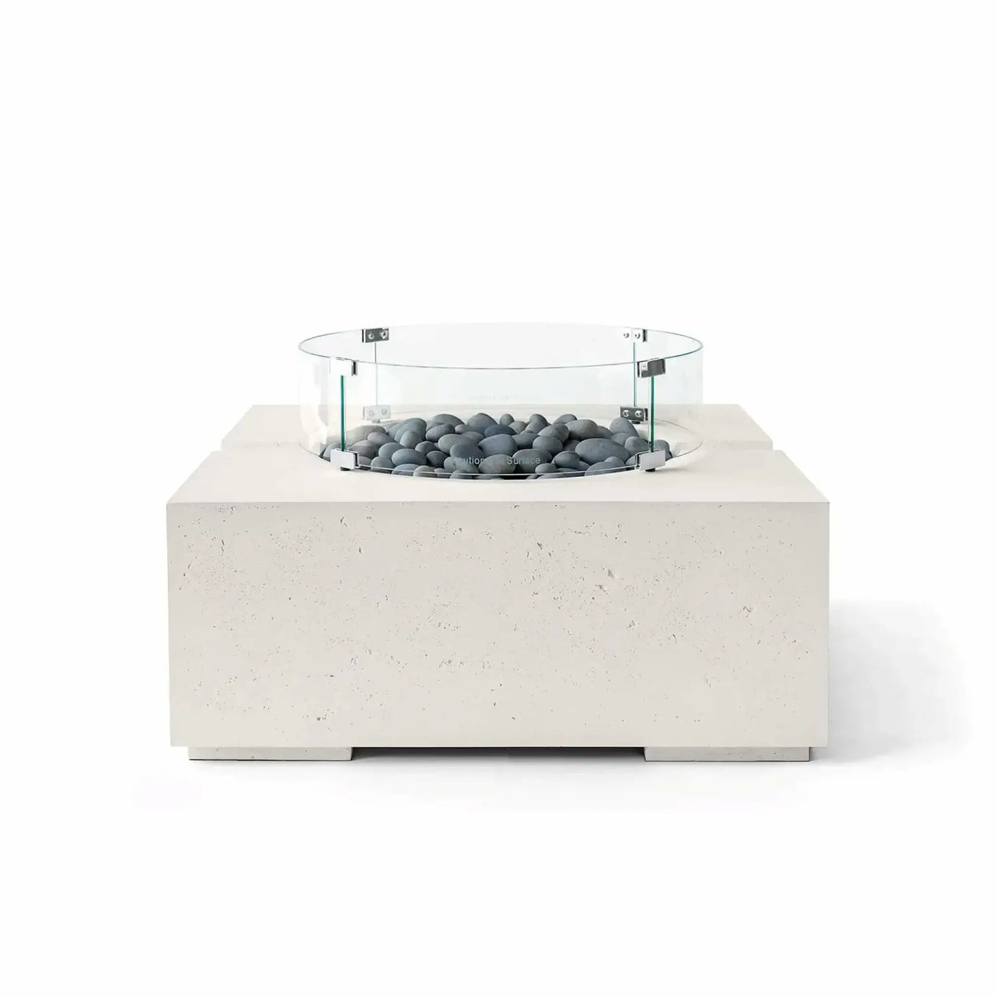 HPC Fire Hearth Products Controls Dekko GFRC Concrete Bravo 32 x 32 Fire Pit in Limestone finish with Slate Stone fire media and a tempered glass wind guard. Smooth gray decorative stones complement the light GFRC concrete body, highlighting the fire pit’s contemporary square silhouette, textured finish, and minimalist outdoor design in a clean white-background product photograph.