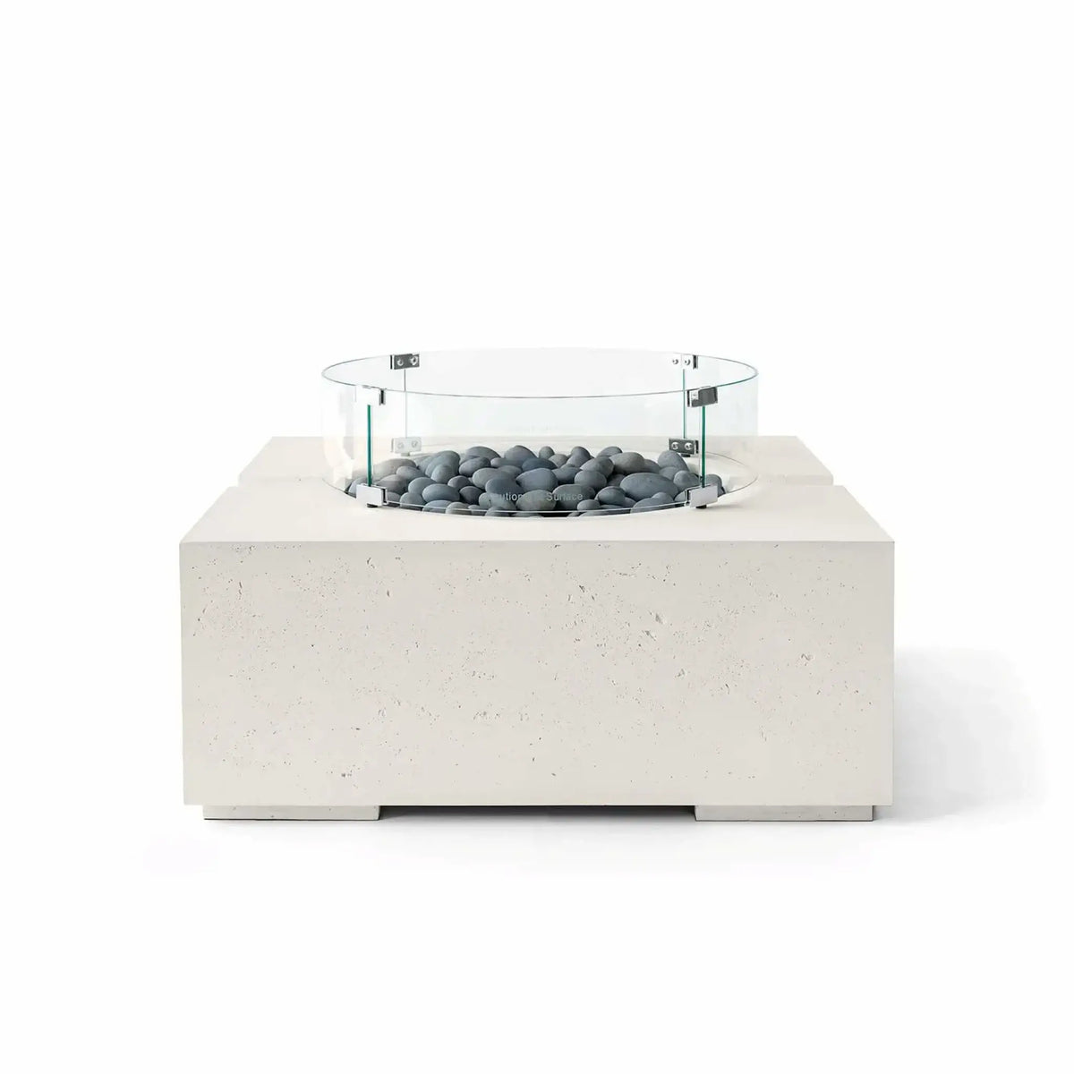 HPC Fire Hearth Products Controls Dekko GFRC Concrete Bravo 32 x 32 Fire Pit in Limestone finish with Slate Stone fire media and a tempered glass wind guard. Smooth gray decorative stones complement the light GFRC concrete body, highlighting the fire pit’s contemporary square silhouette, textured finish, and minimalist outdoor design in a clean white-background product photograph.