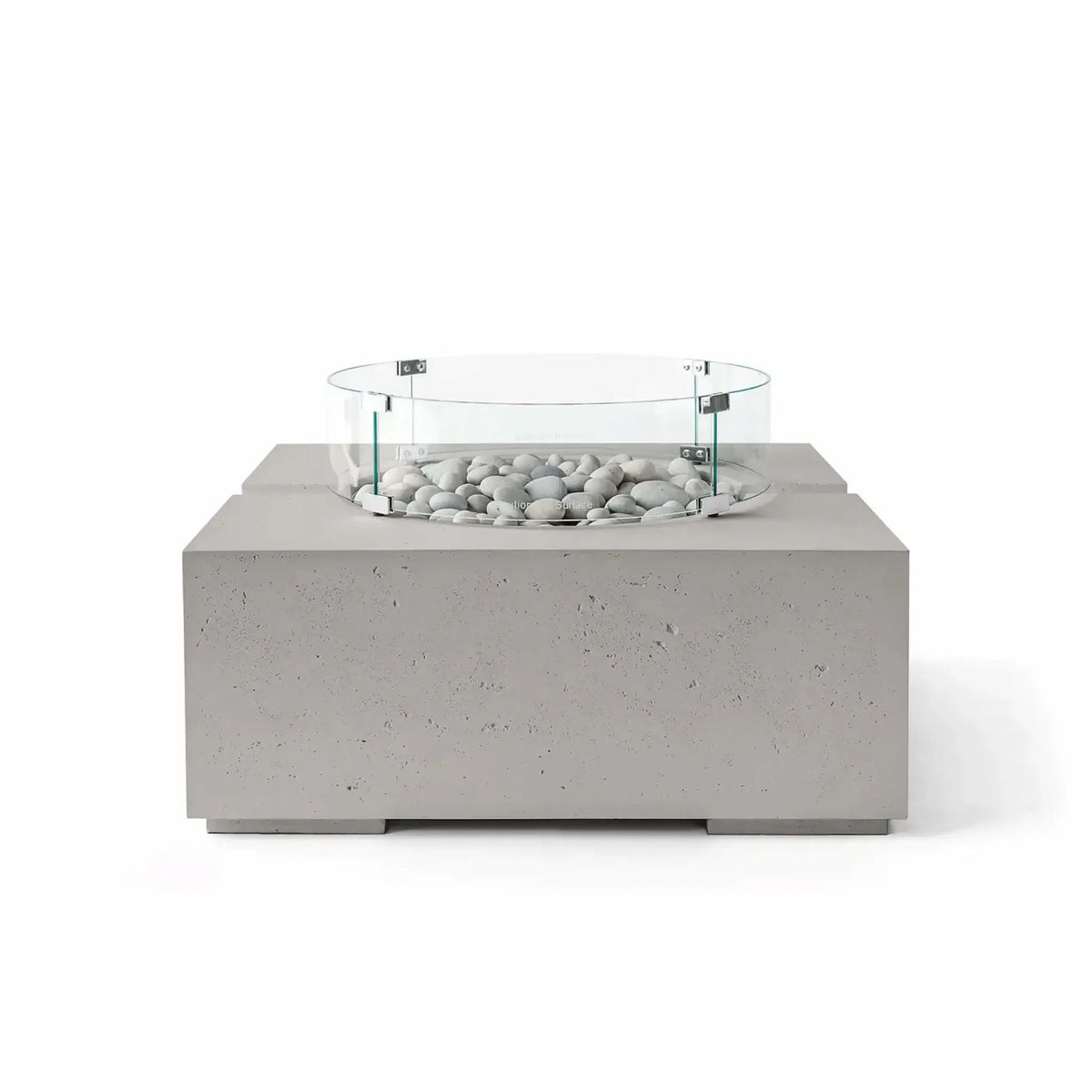 HPC Fire Hearth Products Controls Dekko GFRC Concrete Bravo 32 x 32 Fire Pit in Sandstone finish with Ivory Stone fire media and a clear tempered glass wind guard. The warm beige concrete texture pairs naturally with the light decorative stones, creating an inviting outdoor fire feature with a contemporary square design and premium architectural styling.