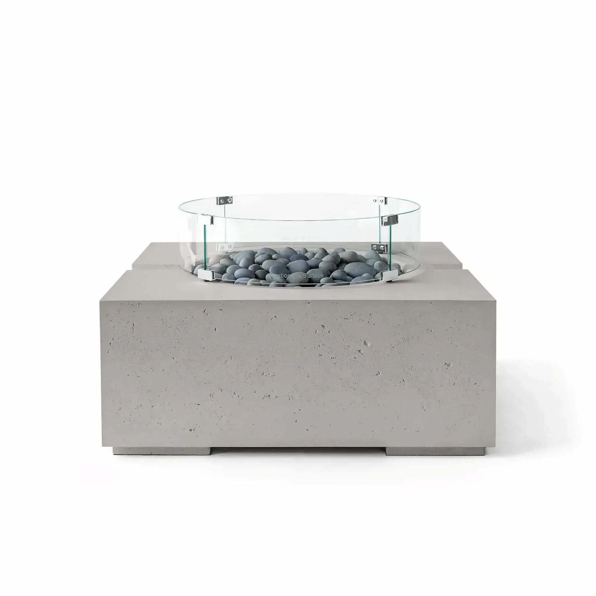 HPC Fire Hearth Products Controls Dekko GFRC Concrete Bravo 32 x 32 Fire Pit in Sandstone finish with Slate Stone fire media and a clear tempered glass wind guard. The combination of warm beige concrete and smooth gray stones delivers a refined contemporary look, while the square fire pit design and textured GFRC construction provide lasting outdoor style.