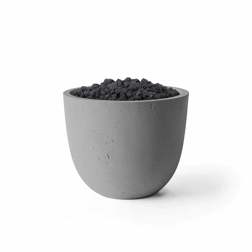 HPC Fire Hearth Products Controls Dekko GFRC Concrete Element 20 Round Fire Column finished in Charcoal and filled with natural lava rock media. The contemporary rounded fire column features a dark gray concrete exterior with subtle texture and a recessed burner area topped with black volcanic rock. Product image presented on a clean white background for outdoor fire feature and patio design applications.