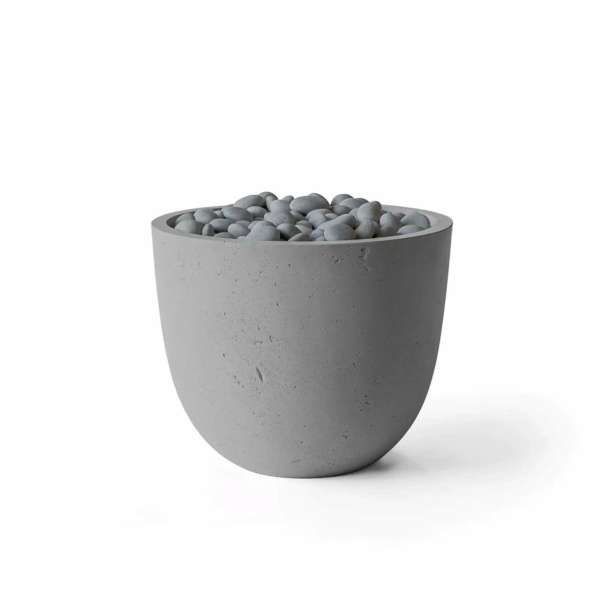 Dekko GFRC Concrete Element 20 Round Fire Column by HPC in a Charcoal finish with Slate Stone decorative media. The modern fire column combines a dark gray GFRC concrete body with polished gray stones surrounding the burner area. Studio product image on a white background highlighting the rounded silhouette, textured concrete surface, and contemporary outdoor fire feature styling.