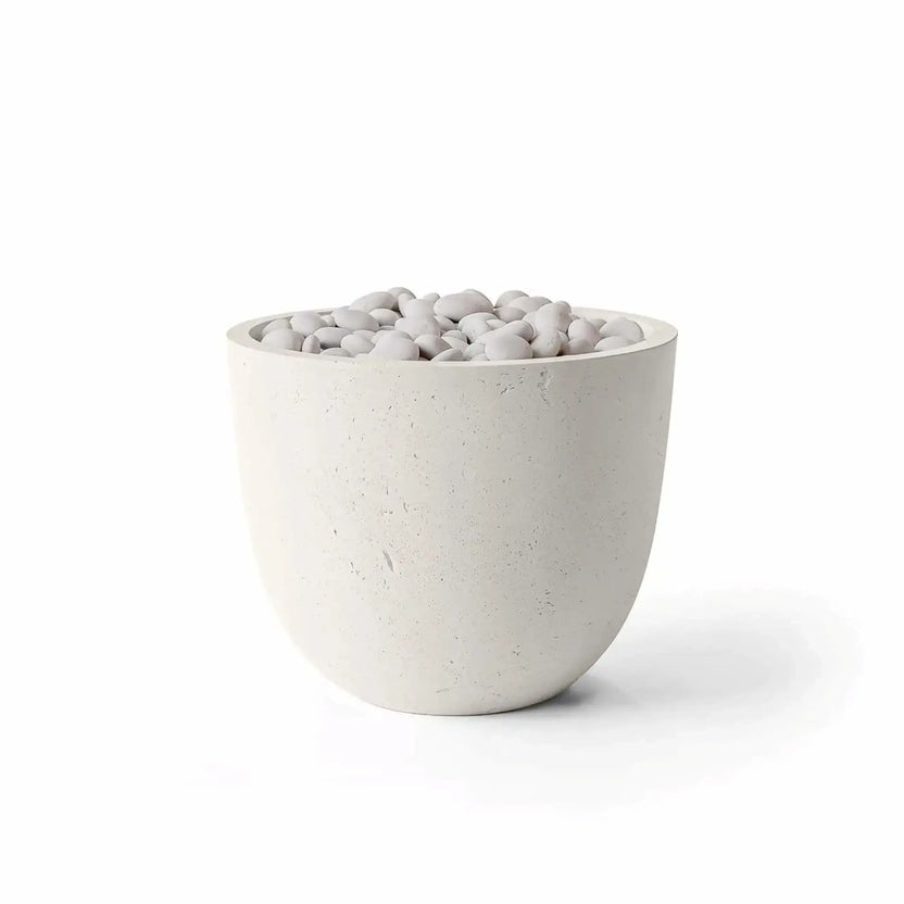 Dekko GFRC Concrete Element 20 Round Fire Column by HPC Fire Hearth Products Controls featuring a Limestone finish and Ivory Stone fire media. The fire column has a rounded bowl-like silhouette with a light off-white concrete texture and smooth ivory decorative stones filling the burner opening. Product image isolated on a white background, emphasizing the Limestone GFRC construction and elegant Ivory Stone media combination for outdoor fire pit installations.