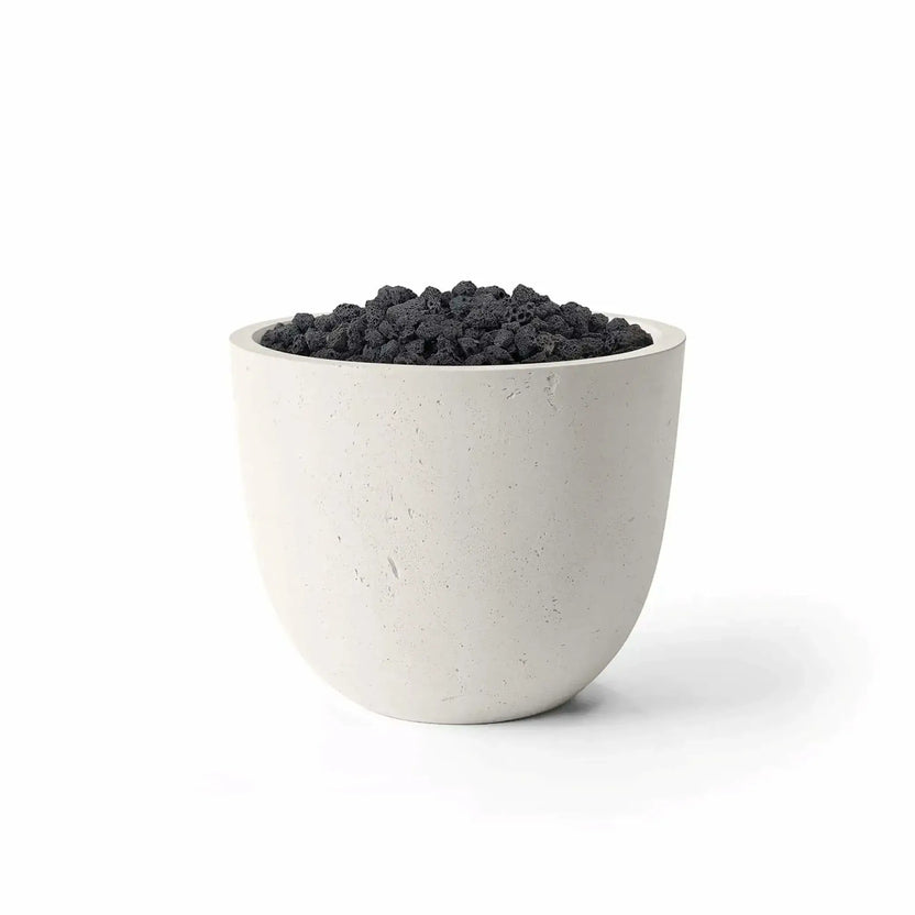 HPC Dekko GFRC Concrete Element 20 Round Fire Column in a Limestone finish paired with black Lava Rock media. The contemporary outdoor fire feature displays a smooth rounded GFRC concrete body with a light neutral tone and a recessed burner area filled with rugged volcanic rock. Studio product image on a white background showcasing the contrast between the Limestone concrete finish and natural Lava Rock fire media.