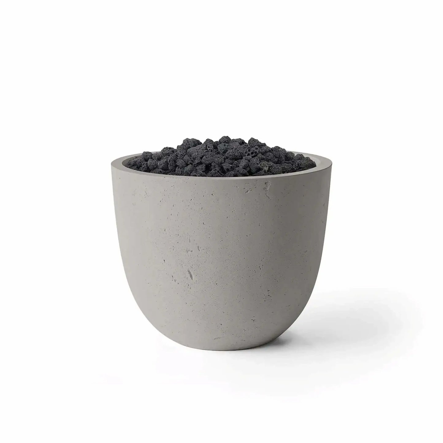 Dekko GFRC Concrete Element 20 Round Fire Column by HPC in a Sandstone finish paired with black Lava Rock media. The contemporary fire column features a rounded GFRC concrete exterior with a warm sandstone tone and a recessed burner area filled with natural volcanic rock. Studio product image on a white background highlighting the Sandstone finish, textured concrete surface, and rugged Lava Rock fire media.