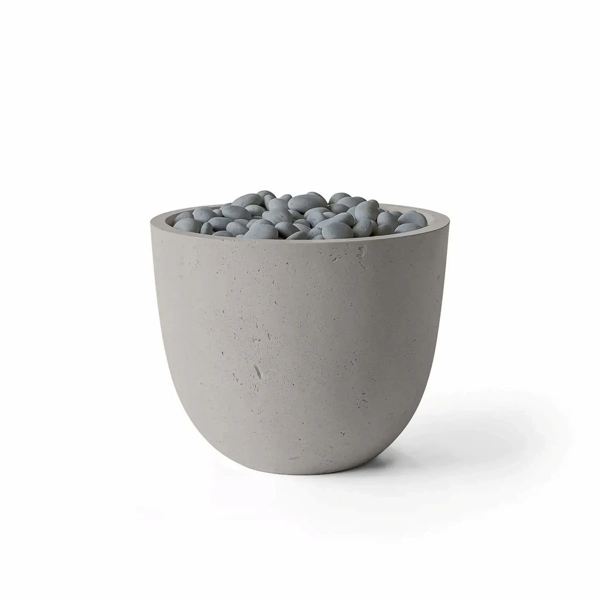 HPC Fire Hearth Products Controls Dekko GFRC Concrete Element 20 Round Fire Column featuring a Sandstone finish and Slate Stone media. The rounded outdoor fire feature combines a warm beige GFRC concrete body with smooth gray slate stones filling the burner opening. Clean product photography on a white background emphasizes the Sandstone concrete texture, contemporary shape, and decorative Slate Stone fire media.