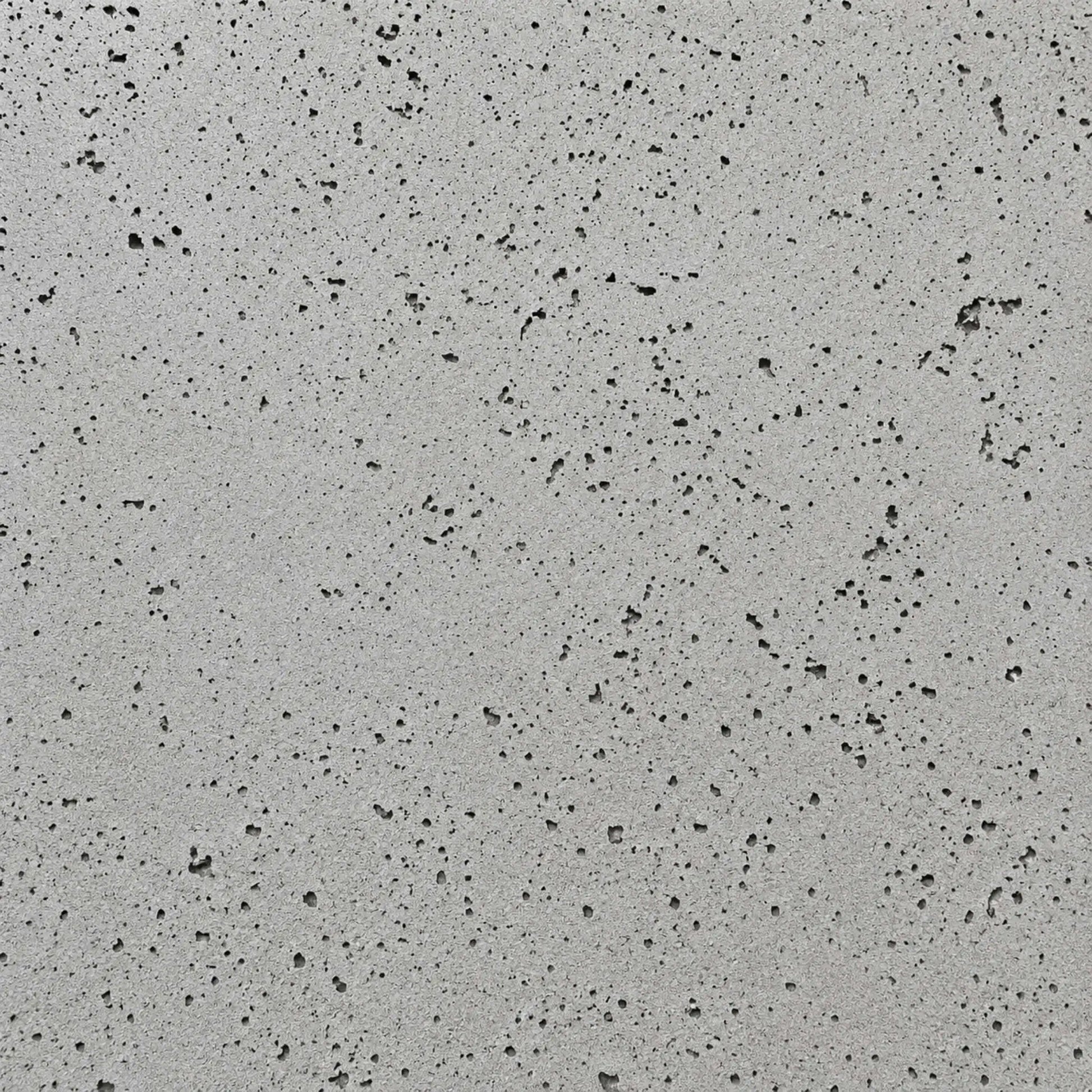 Close-up swatch of HPC Fire Hearth Products Dekko GFRC Concrete Fire Pit Charcoal finish, showcasing a medium gray concrete surface accented by darker pores and natural texture variations. The contemporary charcoal finish delivers a refined industrial look suitable for modern outdoor fire pits, gas fire tables, and custom backyard fire feature designs.