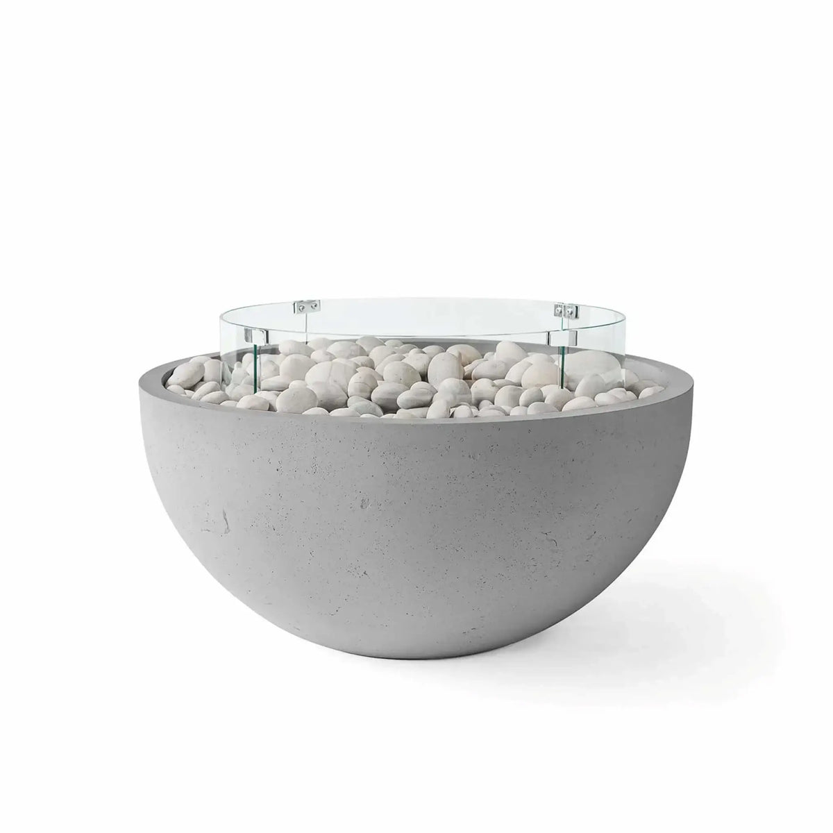 HPC Fire Hearth Products Controls Dekko GFRC Concrete Serenade 32 Fire Pit in Charcoal finish with ivory fire stones and a tempered glass wind guard. The dark concrete bowl contrasts beautifully with the smooth white stones, highlighting its modern outdoor fire feature design, durable GFRC construction, and contemporary styling for patios, terraces, and backyard seating areas.