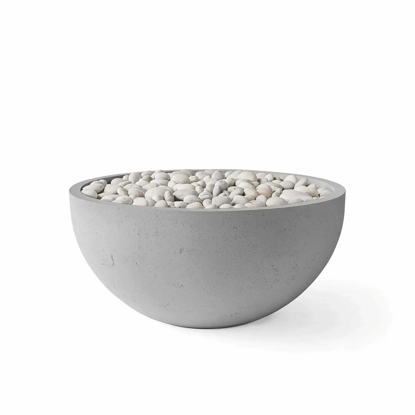 HPC Fire Hearth Products Controls Dekko GFRC Concrete Serenade 32 Fire Pit in Charcoal finish featuring ivory stone fire media. This round GFRC concrete fire bowl combines a dark charcoal gray exterior with polished white decorative stones for a striking contrast. The contemporary bowl-shaped design is shown in a studio product image on a white background, ideal for modern outdoor patio and backyard fire pit installations.