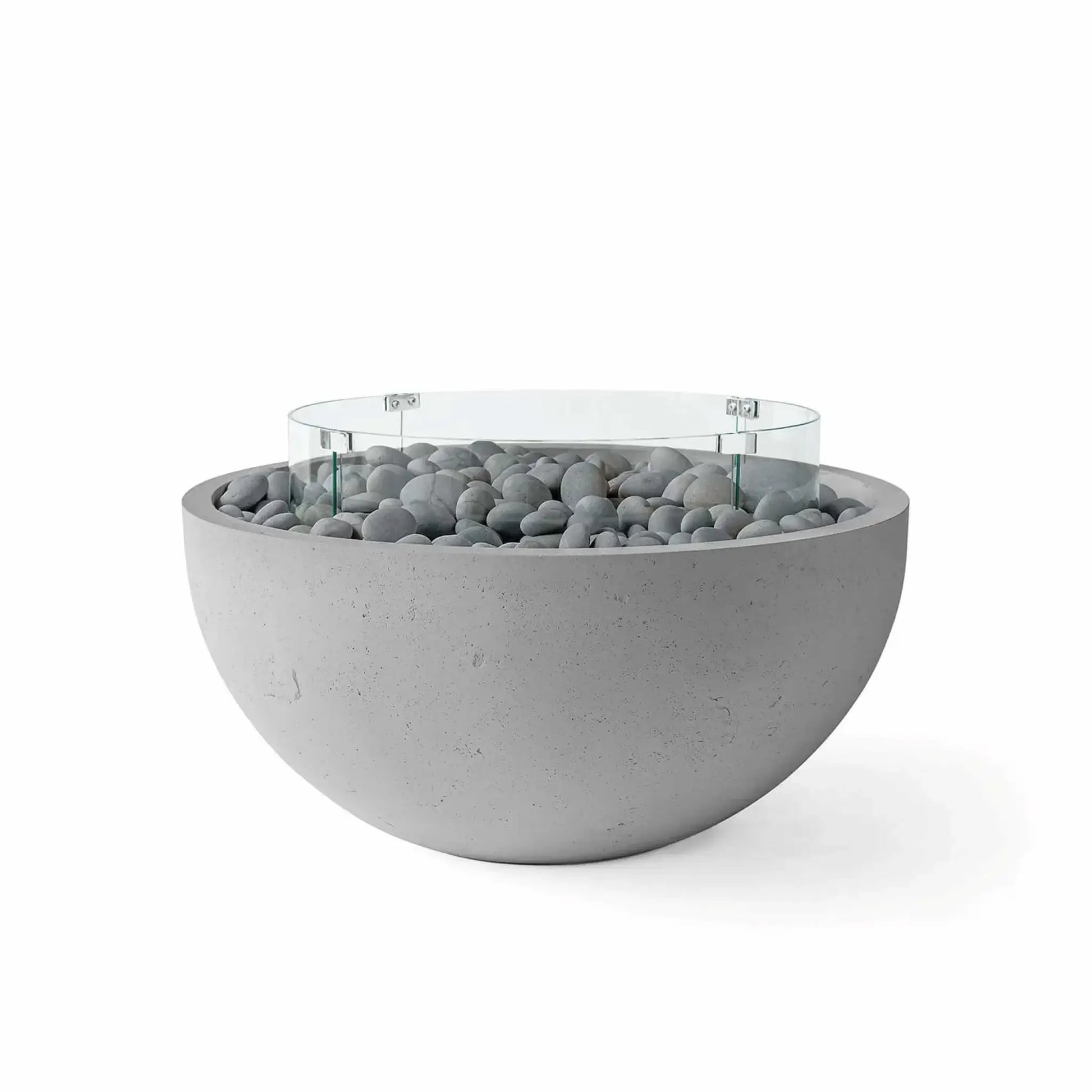 HPC Fire Hearth Products Controls Dekko GFRC Concrete Serenade 32 Fire Pit in Charcoal finish with smooth slate stones and a clear tempered glass wind guard. The rounded GFRC concrete fire bowl features subtle texture, contemporary styling, and decorative gray stone media, creating a sophisticated outdoor fire feature for patios, rooftops, and backyard entertaining spaces.