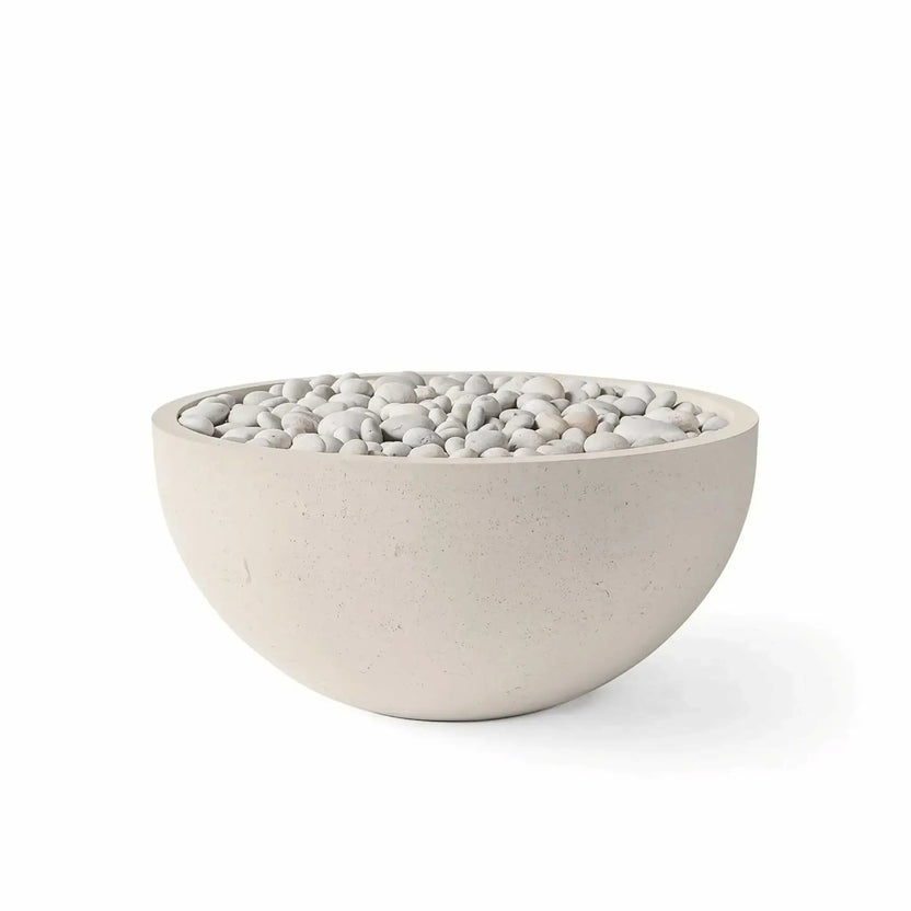 HPC Fire Hearth Products Controls Dekko GFRC Concrete Serenade 32 Fire Pit in Clay finish featuring ivory stone fire media. This round GFRC concrete fire bowl displays a warm beige clay-colored exterior with decorative ivory stones arranged across the burner area. The smooth curved design and neutral color palette make it ideal for outdoor patios, poolside seating areas, and contemporary backyard fire pit installations.