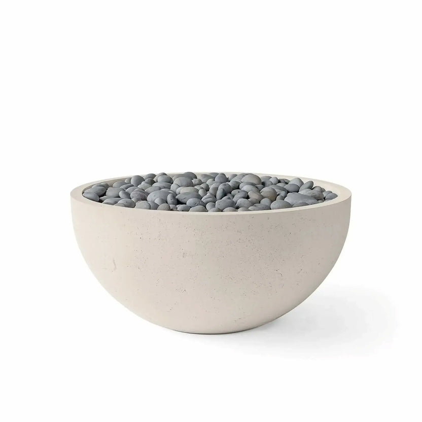 HPC Fire Hearth Products Controls Dekko GFRC Concrete Serenade 32 Fire Pit in Clay finish with slate stone fire media. The contemporary round fire bowl is constructed from durable GFRC concrete and features a warm beige exterior paired with smooth gray slate stones across the burner area. Studio product image on a white background showcases the elegant outdoor fire feature for patios, courtyards, and backyard living spaces.