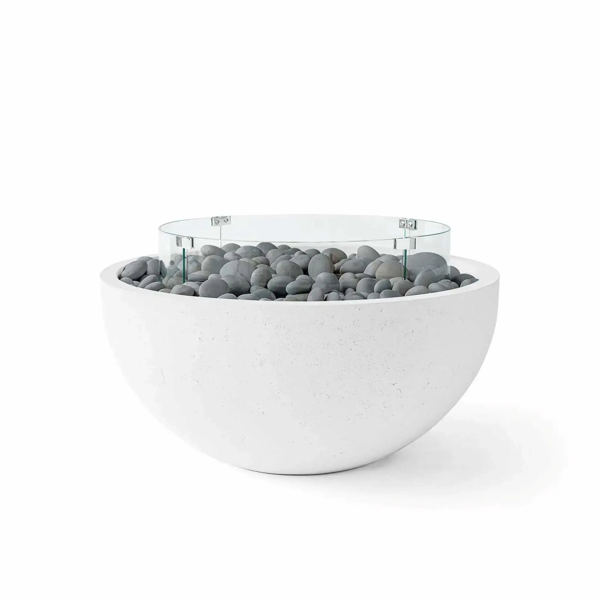 HPC Fire Hearth Products Controls Dekko GFRC Concrete Serenade 32 Fire Pit in Natural finish featuring decorative slate stones beneath a clear tempered glass wind guard. The smooth gray stone media complements the light GFRC concrete bowl, creating a sophisticated and modern outdoor fire feature designed for upscale patios, courtyards, pool decks, and entertaining spaces.