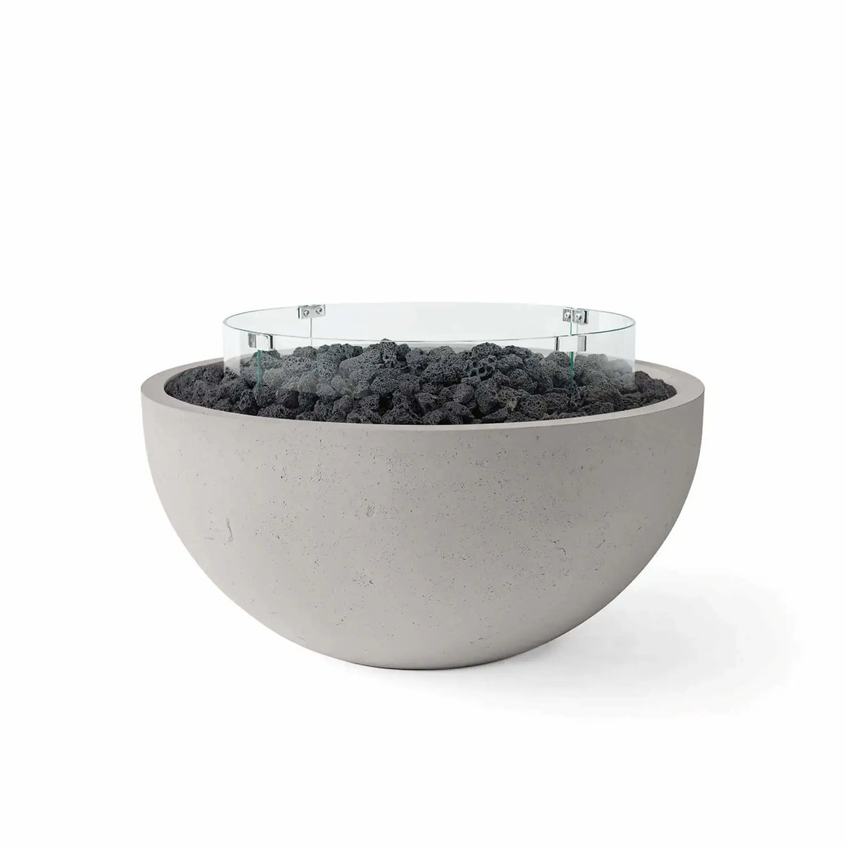 HPC Fire Hearth Products Controls Dekko GFRC Concrete Serenade 32 Fire Pit in Sandstone finish featuring black lava rock media and a circular tempered glass wind guard. The warm-toned GFRC concrete fire bowl contrasts beautifully with the volcanic rock fill, delivering a clean contemporary aesthetic perfect for outdoor patios, poolside gathering areas, and modern backyard living spaces.