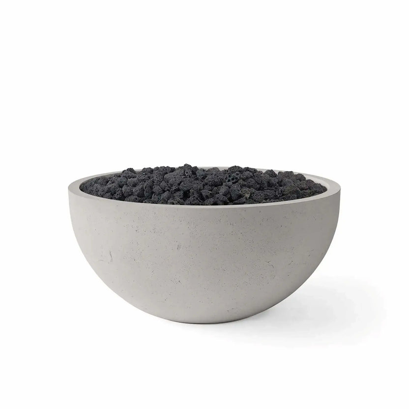 HPC Fire Hearth Products Controls Dekko GFRC Concrete Serenade 32 Fire Pit in Sandstone finish with Lava Rock media. This round GFRC concrete fire bowl features a warm sandstone-colored exterior paired with rugged black lava rock, creating a striking contrast that complements contemporary outdoor living spaces. Displayed on a clean white background, the image highlights the smooth bowl profile, durable concrete texture, and premium lava rock media option available for the Serenade 32 Fire Pit collection.