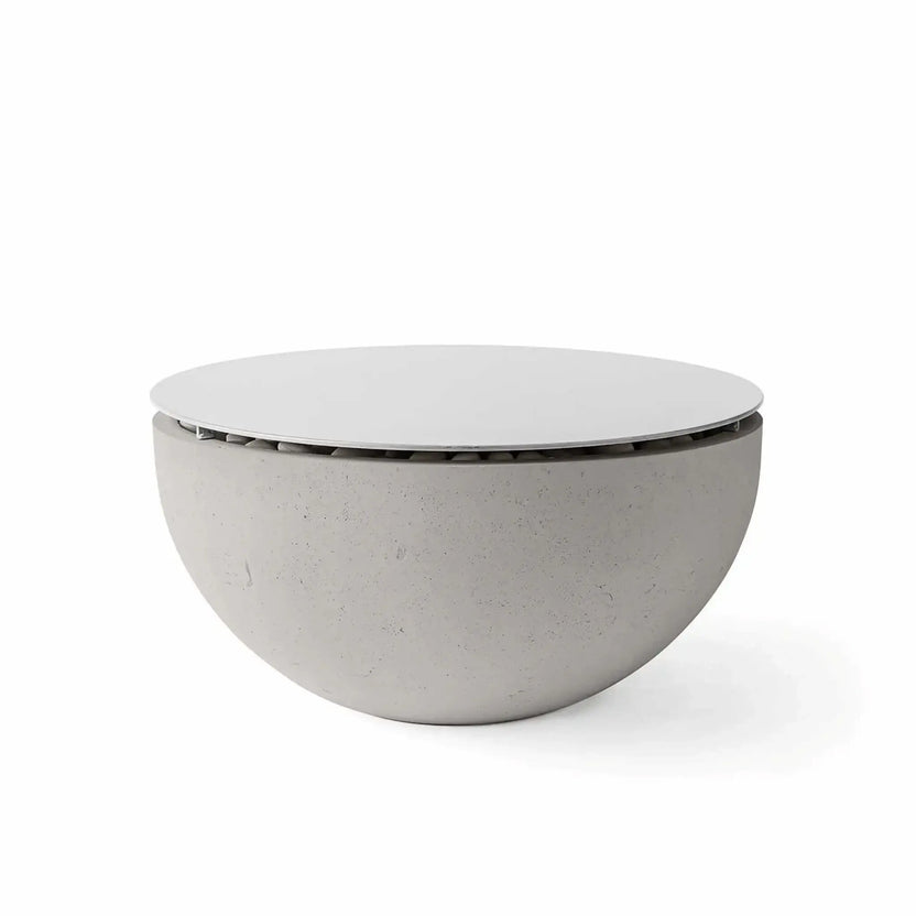 HPC Fire Hearth Products Controls Dekko GFRC Concrete Serenade 32 Fire Pit in Sandstone finish with Table Top Lid installed. The light sandstone-colored concrete bowl is paired with a smooth circular cover that creates additional usable surface space when the fire pit is not operating. Displayed on a white background, the image showcases the subtle concrete texture, rounded silhouette, and versatile design of the Serenade 32 fire pit.