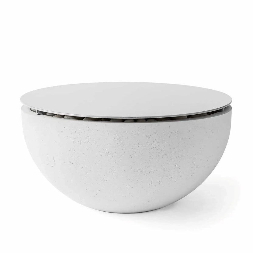 HPC Fire Hearth Products Controls Dekko GFRC Concrete Serenade 40 Fire Pit Ash Table Top Lid installed on an ash-colored Serenade 40 fire pit table. The round metal lid covers the burner area to create a functional tabletop surface while protecting fire media and internal components. The contemporary bowl-shaped GFRC concrete fire pit features a soft ash finish and minimalist outdoor design.