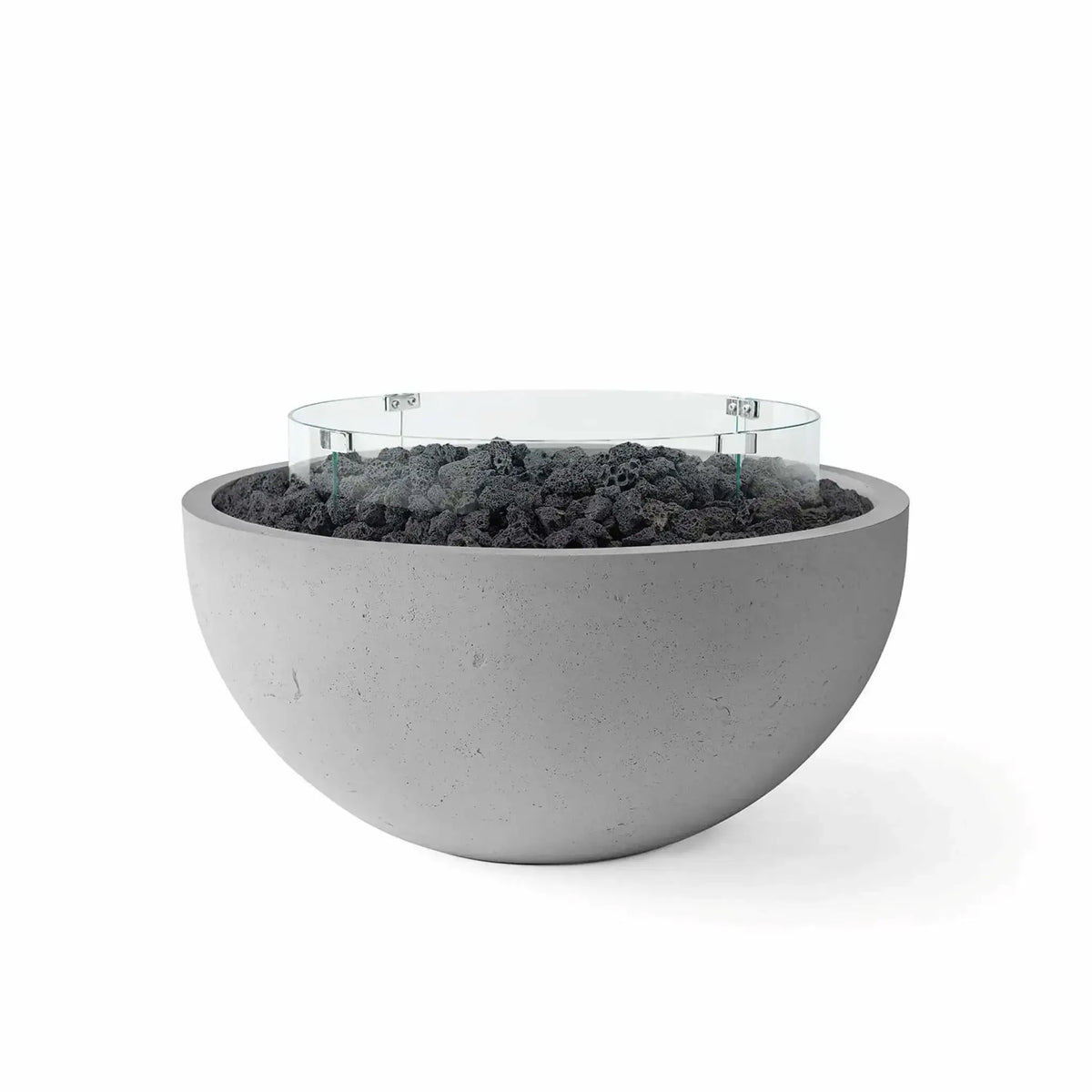HPC Fire Hearth Products Controls Dekko GFRC Concrete Serenade 40 Fire Pit in Charcoal finish with black lava rock media and a clear tempered glass wind guard. This modern round GFRC concrete fire bowl features a rich charcoal-gray exterior, rugged volcanic rock fill, and a circular glass windscreen that enhances flame performance while maintaining a clean, contemporary outdoor aesthetic.