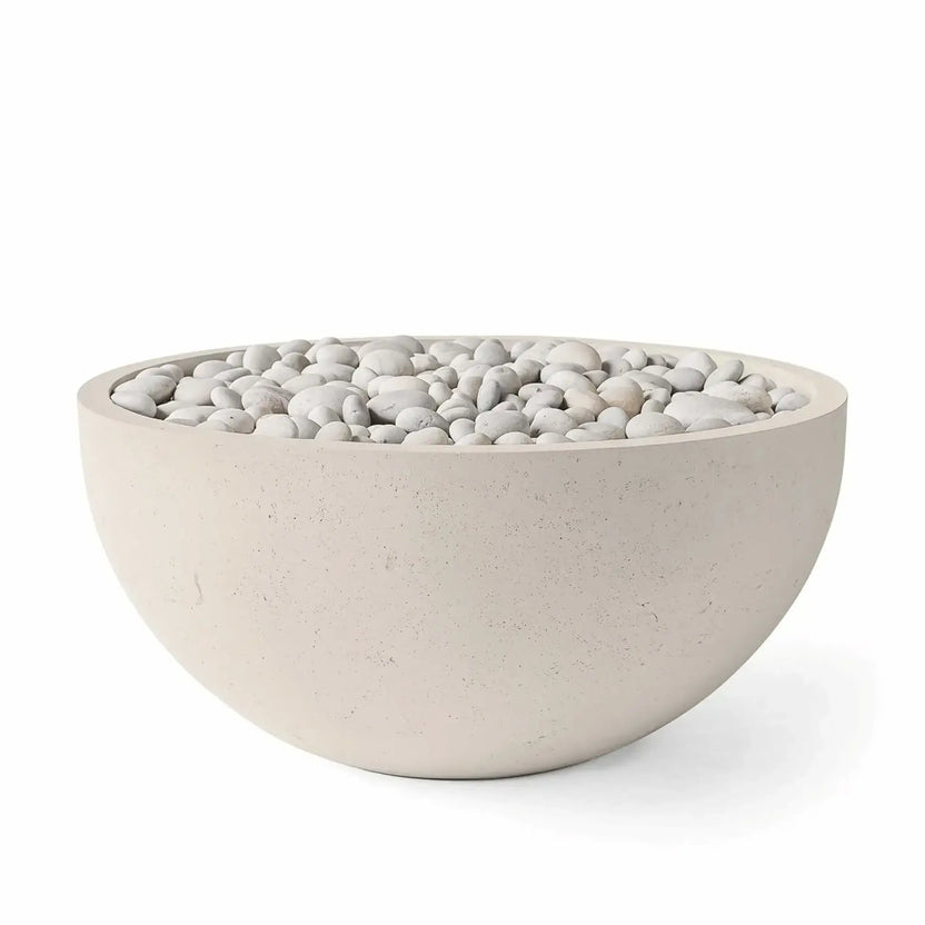 HPC Fire Hearth Products Controls Dekko GFRC Concrete Serenade 40 Fire Pit in Clay finish featuring ivory decorative stones. The round GFRC concrete fire bowl has a warm beige concrete color, subtle textured surface, and smooth white river stones covering the burner area. Product image showcases the elegant contemporary fire pit design, ideal for outdoor patios, garden seating areas, and luxury backyard landscapes.