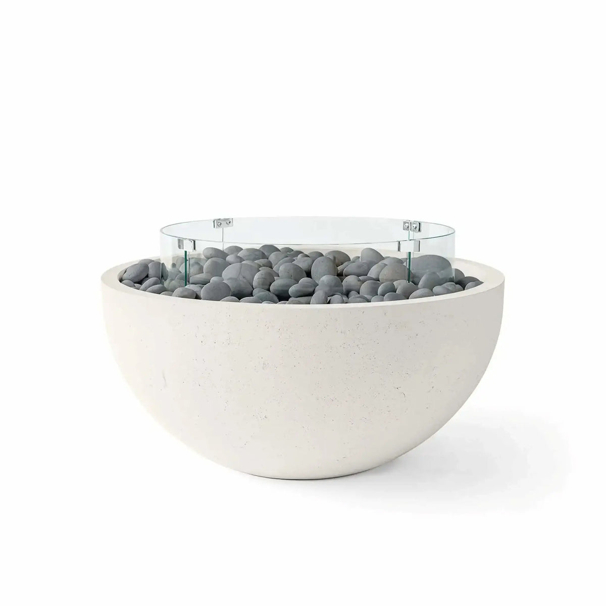 HPC Fire Hearth Products Controls Dekko GFRC Concrete Serenade 40 Fire Pit in Limestone finish with smooth slate stone fire media and a tempered glass wind guard. The rounded concrete bowl showcases durable GFRC construction, soft gray decorative stones, and a transparent circular windscreen that enhances both safety and style, making it a sophisticated focal point for modern outdoor living and patio environments.