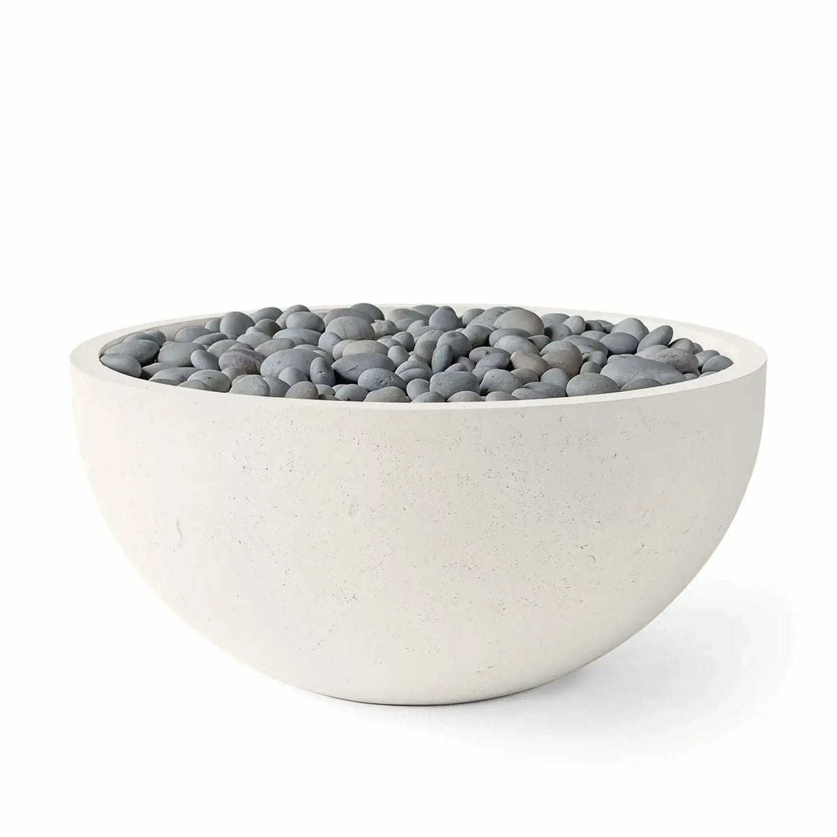 HPC Fire Hearth Products Controls Dekko GFRC Concrete Serenade 40 Fire Pit in Limestone finish with Slate Stone media. The image presents a smooth round GFRC concrete fire bowl filled with polished gray stones, emphasizing the neutral color palette, refined texture, and contemporary styling that complements residential patios, courtyards, and outdoor living environments.