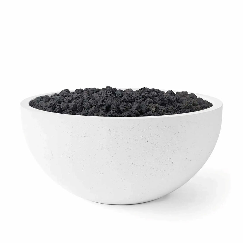 HPC Fire Hearth Products Controls Dekko GFRC Concrete Serenade 40 Fire Pit in Natural finish featuring Lava Rock media. The image showcases a round GFRC concrete fire bowl filled with textured black volcanic rock, highlighting the contrast between the natural concrete exterior and rugged fire media for a bold contemporary outdoor fire pit design.