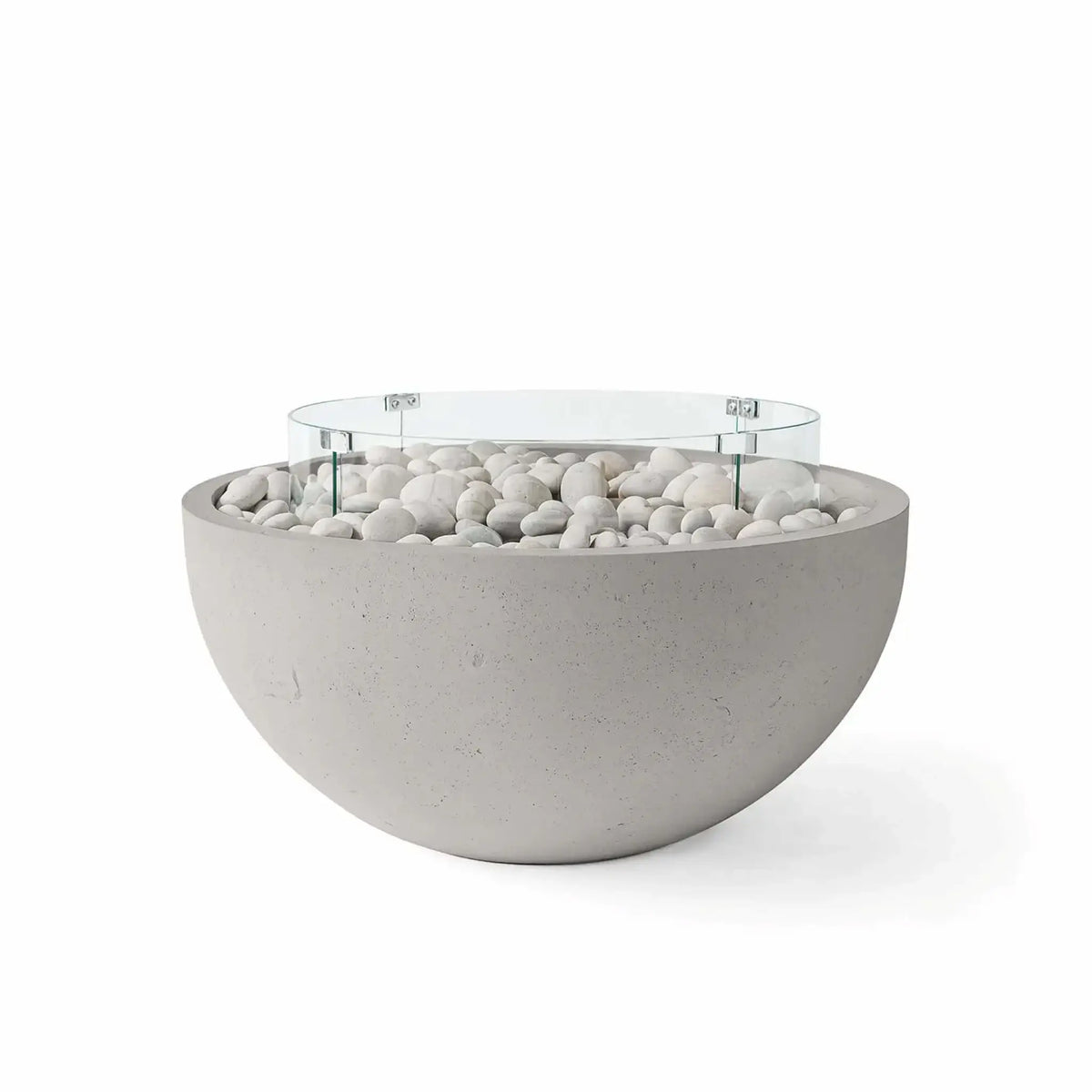 HPC Fire Hearth Products Controls Dekko GFRC Concrete Serenade 40 Fire Pit in Sandstone finish with ivory stone fire media and a tempered glass wind guard. The warm sandstone-colored GFRC concrete bowl is accented by smooth white river stones and a circular glass flame barrier, creating a welcoming and sophisticated outdoor centerpiece perfect for patios, courtyards, and luxury residential landscapes.