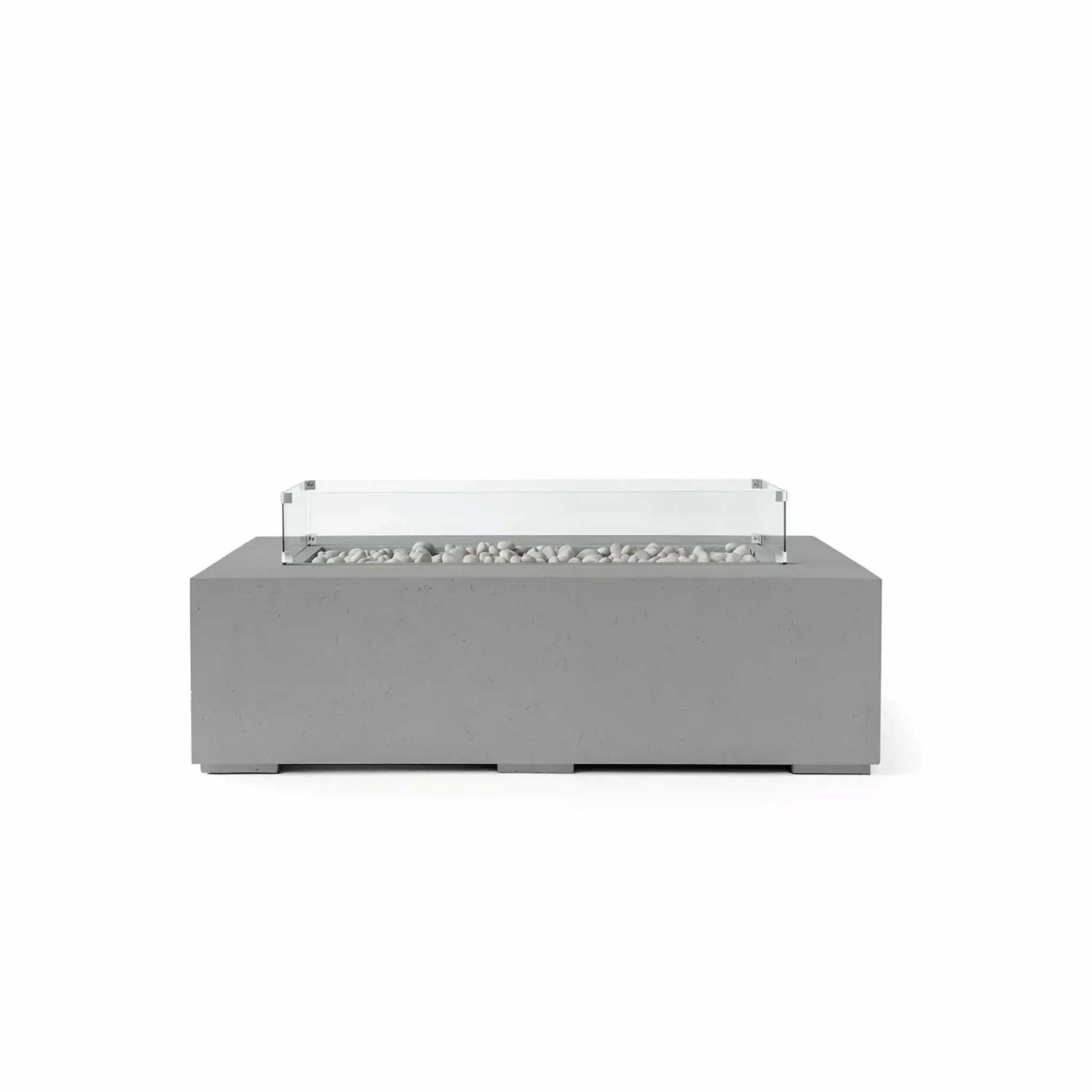 HPC Fire Hearth Products Controls Dekko GFRC Concrete Sonoma 56 x 30 Fire Pit in Charcoal finish featuring Ivory Stone media and a tempered glass wind guard. The dark charcoal concrete exterior contrasts beautifully with the smooth ivory fire stones inside the linear burner tray. A transparent glass wind guard surrounds the burner area, creating a refined modern aesthetic that complements luxury patios, rooftop lounges, and contemporary outdoor living environments.