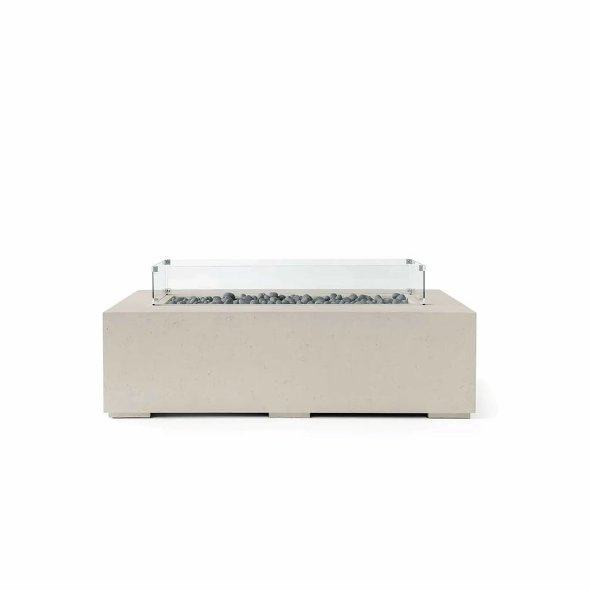 HPC Fire Hearth Products Controls Dekko GFRC Concrete Sonoma 56 x 30 Fire Pit in Clay finish with Slate Stone media and a tempered glass wind guard. This modern rectangular fire pit features a durable GFRC concrete exterior, decorative gray slate stones lining the linear burner area, and a clear glass wind guard positioned above the burner opening. The combination of warm clay tones and contemporary styling makes it ideal for luxury outdoor living spaces.