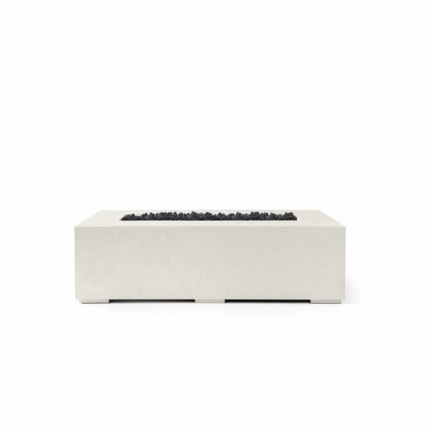 HPC Fire Hearth Products Controls Dekko GFRC Concrete Sonoma 56 x 30 Fire Pit finished in Limestone with black Lava Rock media. The rectangular fire feature combines a light concrete-look exterior with dark volcanic rock in the recessed burner tray, creating strong visual contrast. This studio product image highlights the Sonoma fire pit’s minimalist profile, durable GFRC construction, and contemporary outdoor design.