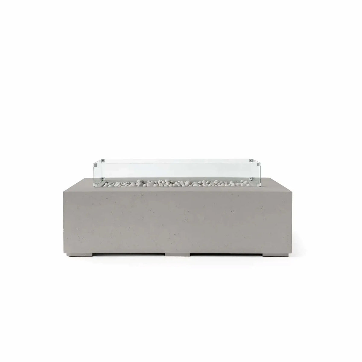 HPC Fire Hearth Products Controls Dekko GFRC Concrete Sonoma 56 x 30 Fire Pit in Sandstone finish with Ivory Stone media and a tempered glass wind guard. The warm sandstone-colored concrete exterior pairs beautifully with smooth ivory fire stones arranged inside the linear burner channel. The clear tempered glass wind guard enhances safety while preserving the clean, contemporary look, making this fire pit ideal for upscale outdoor living and entertaining areas.
