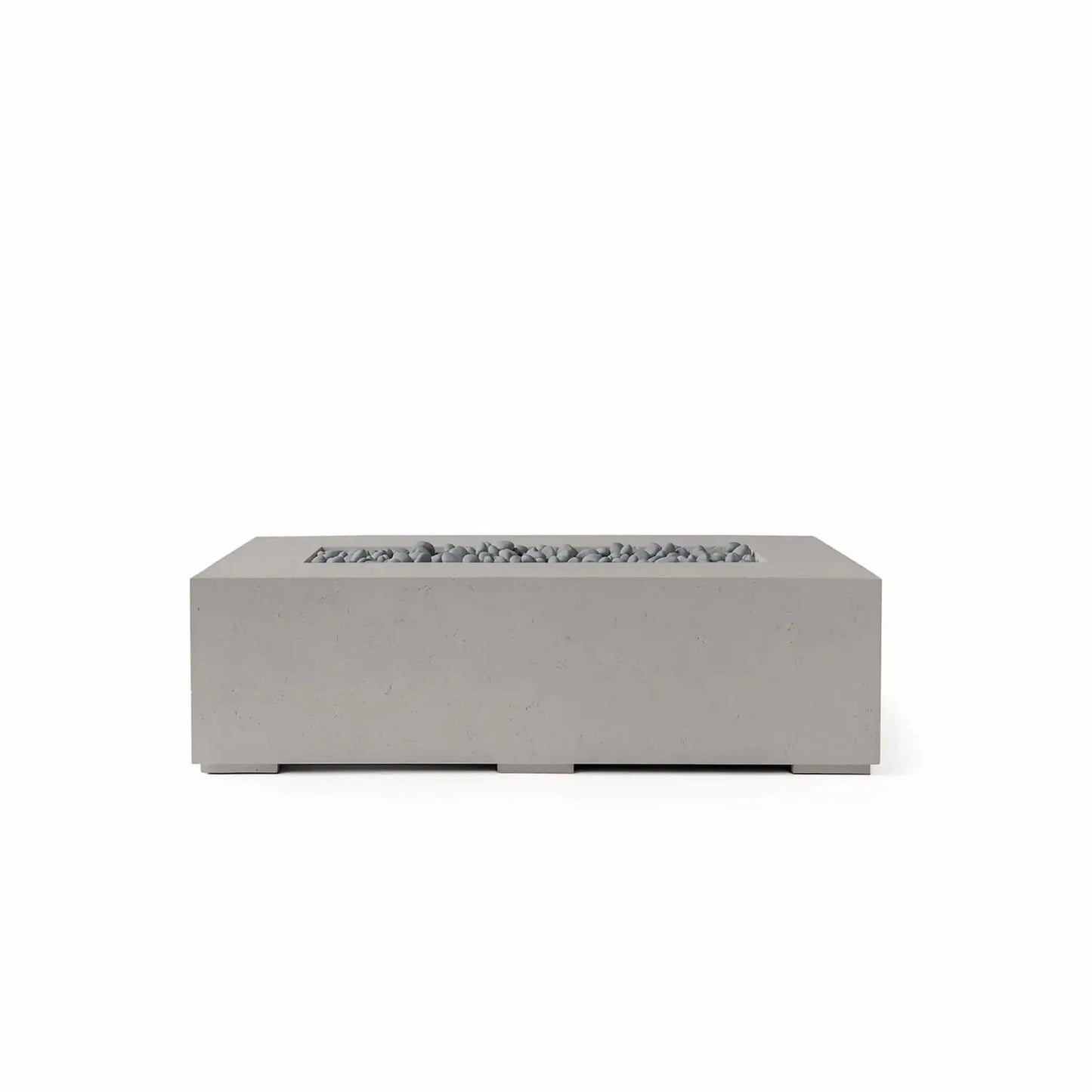 HPC Fire Hearth Products Controls Dekko GFRC Concrete Sonoma 56 x 30 Fire Pit in Sandstone finish with Slate Stone media. This modern rectangular outdoor fire pit features durable glass fiber reinforced concrete construction, a recessed linear burner opening, and decorative gray slate stones that complement the warm sandstone tone. Displayed on a white background, the Sonoma fire pit offers a refined contemporary aesthetic ideal for outdoor living rooms, patios, and luxury landscape designs.