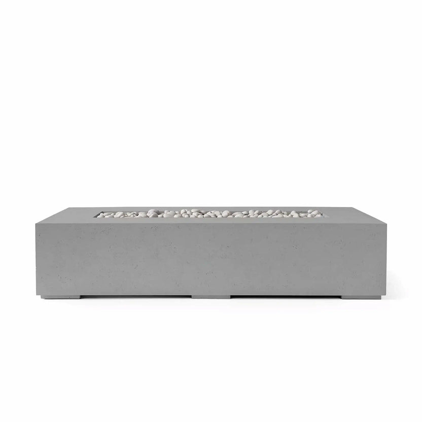 HPC Fire Hearth Products Controls Dekko GFRC Concrete Sonoma 72 x 33 Fire Pit in Charcoal finish with ivory fire stones and a clear tempered glass wind guard. The dark concrete body contrasts beautifully with the light stone media, highlighting the fire feature’s clean rectangular shape and contemporary outdoor design for upscale patios and backyard gathering spaces.