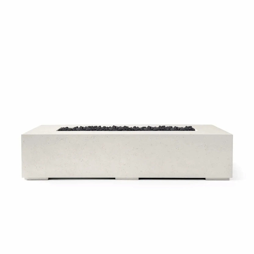 Studio product image of the Dekko Sonoma 72 x 33 GFRC Concrete Fire Pit finished in Limestone and filled with Lava Rock fire media. The rectangular fire pit showcases a minimalist architectural design with a recessed burner channel accented by rugged black lava rock. Presented on a white background, the image emphasizes the contrast between the light concrete finish and dark fire media.