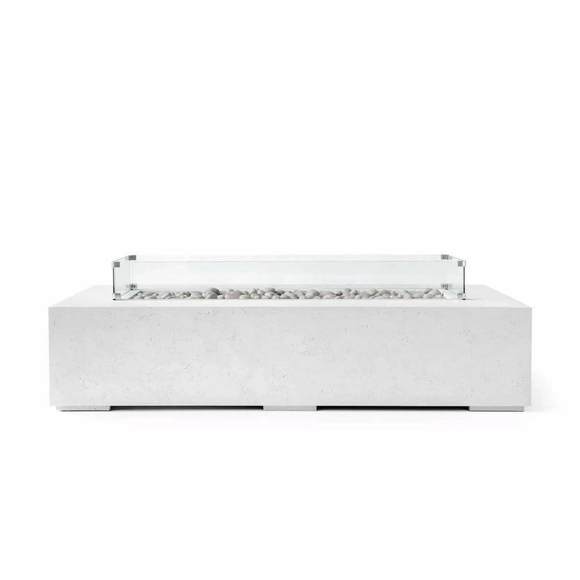 HPC Fire Hearth Products Controls Dekko GFRC Concrete Sonoma 72 x 33 Fire Pit in Natural finish featuring decorative ivory stones and a clear tempered glass wind guard. The light concrete body, sleek rectangular profile, and minimalist styling provide a sophisticated outdoor fire feature designed to complement modern patios, decks, and residential gathering spaces.